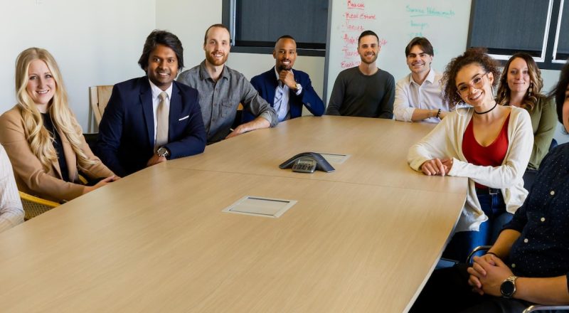 group of people sitting on chair in front of brown wooden table